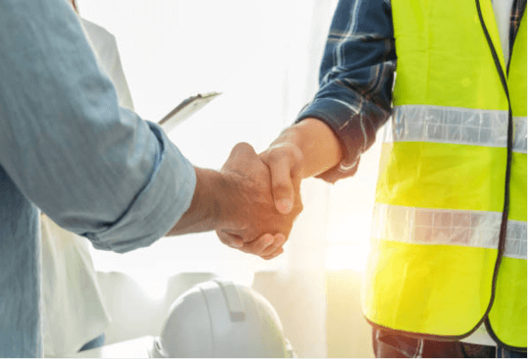 Screenshot-2023-04-05-125000-1 - Aryo Systems A handshake between two people, one wearing a reflective safety vest, symbolizing an agreement in a construction or project setting.
